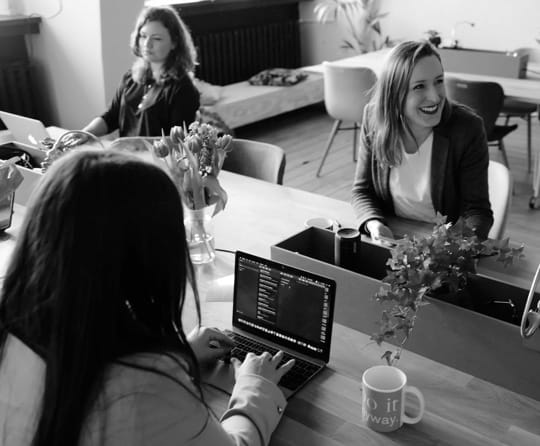 coworkers sitting at a desk